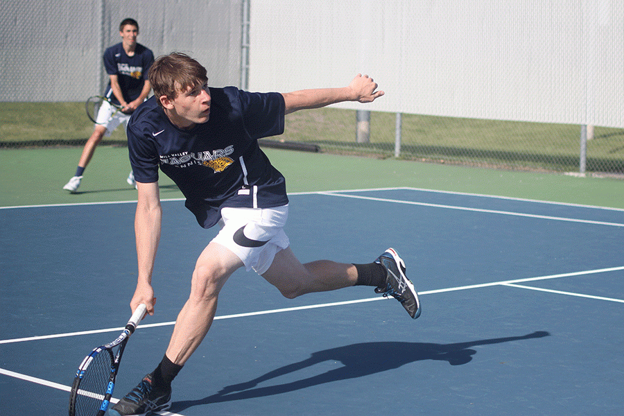 Junior Alec Bergeron crosses the court to hit the ball