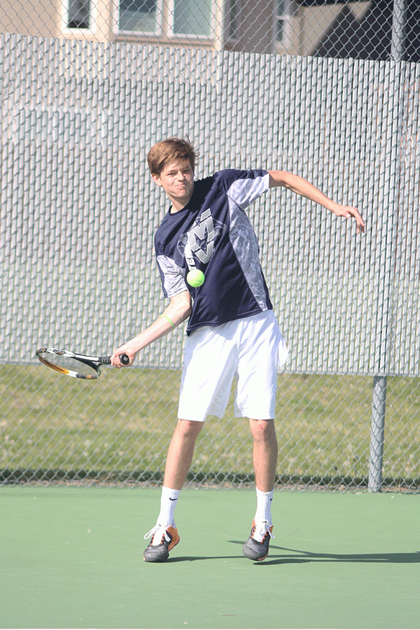 Junior Jansen McCabe focuses on the ball during his singles match.