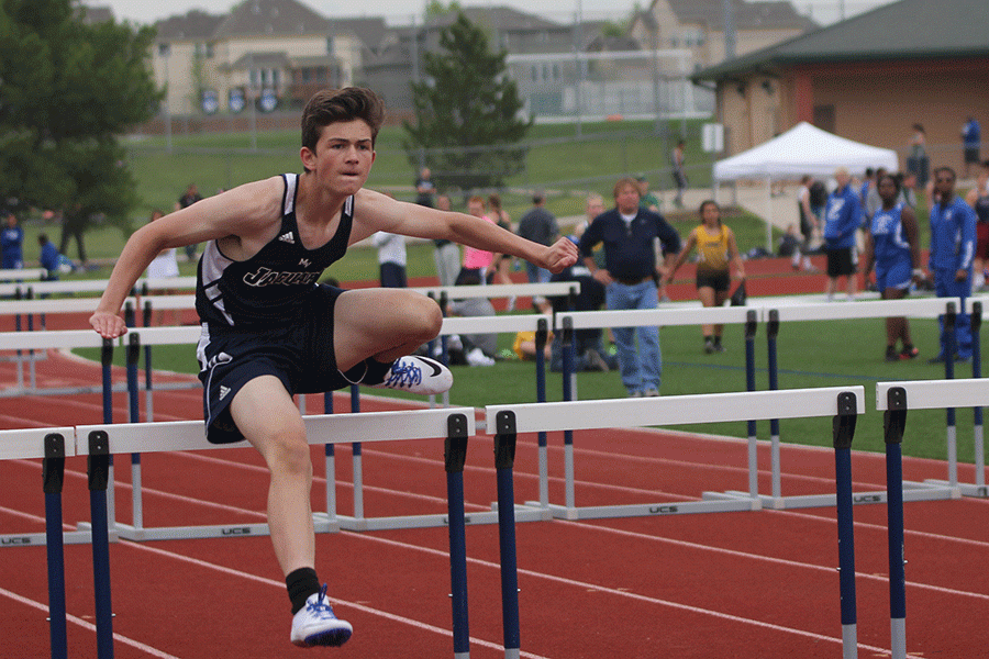 Freshman Wyatt Leonard jumps over a hurdle in the boys 110 meter hurdles.