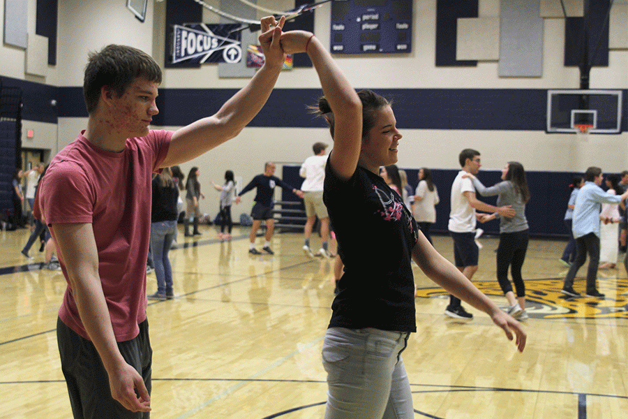 Freshman Bryan States spins freshman Abigail Winters while dancing.