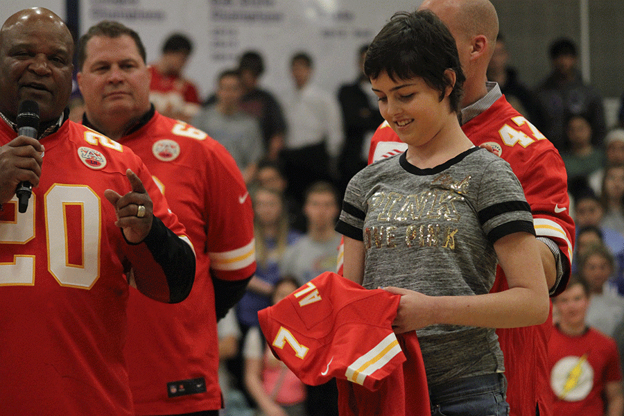 Receiving a jersey with her last name and the number 7 on it to signify perfection, freshman Karsyn Aylward grins.