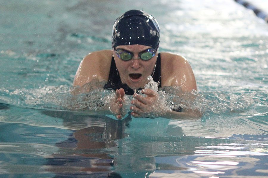 Pushing through the water, junior Elaina Bartlow swims the breaststroke. 