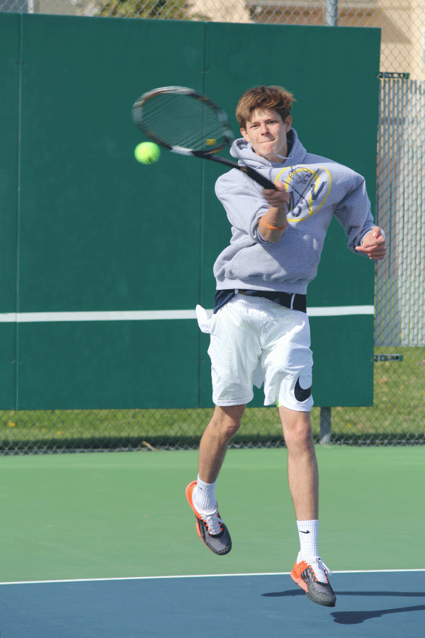 Junior Jansen McCabe returns the serve.