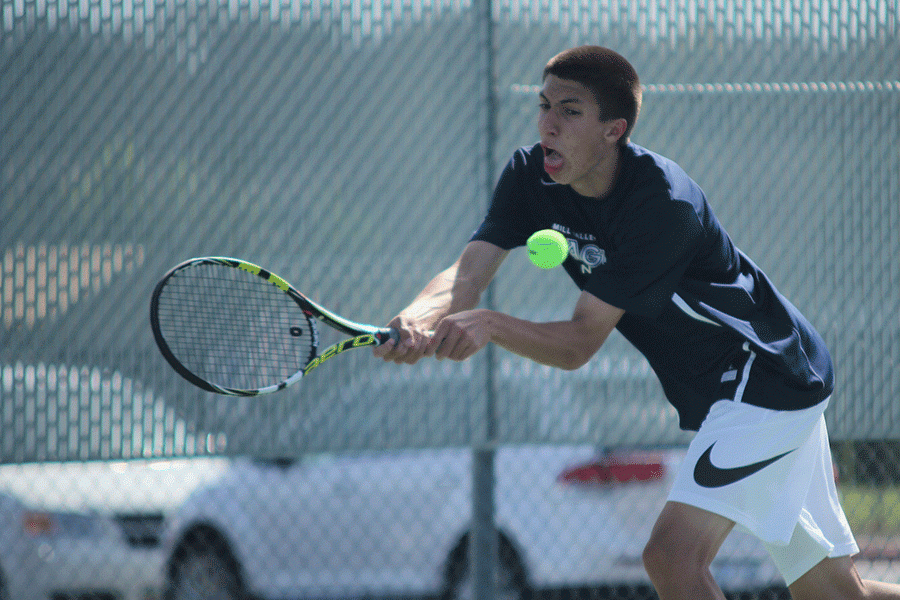Reaching as far as he can, junior Andrew Bock attempts to return the ball to his opponents.