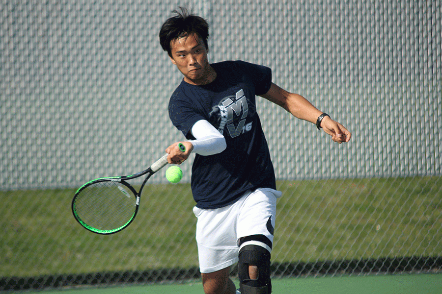 Junior Parker Billings winds up to hit the ball back towards his opponent.