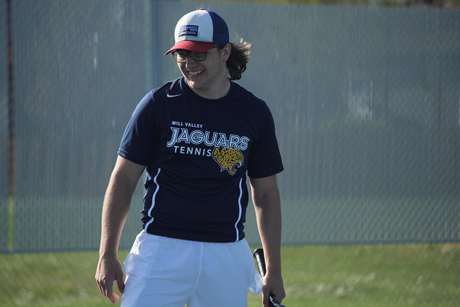 After winning a point in a doubles match with his partner, sophomore Dante Peterson, senior Tyler Shurley laughs to himself.