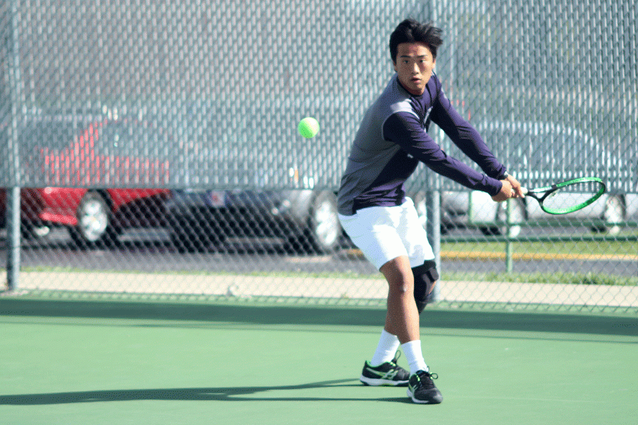 As the ball rushes toward him, junior Parker Billings prepares to return it to his singles opponent at the tennis dual against Kansas City Christian Thursday, April 7. The Jaguars lost the dual, which consisted of three doubles matches and six singles matches.