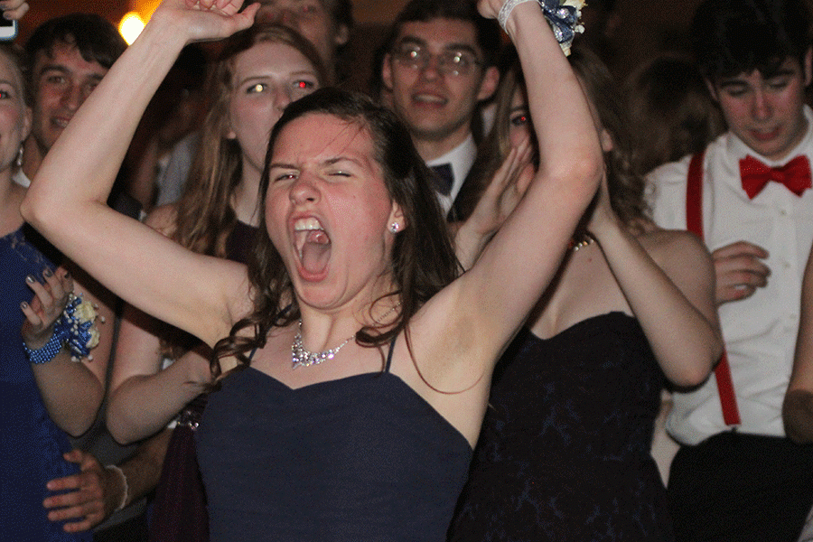 Sophomore Nora Lucas throws her hands up in excitement after a song ends. 