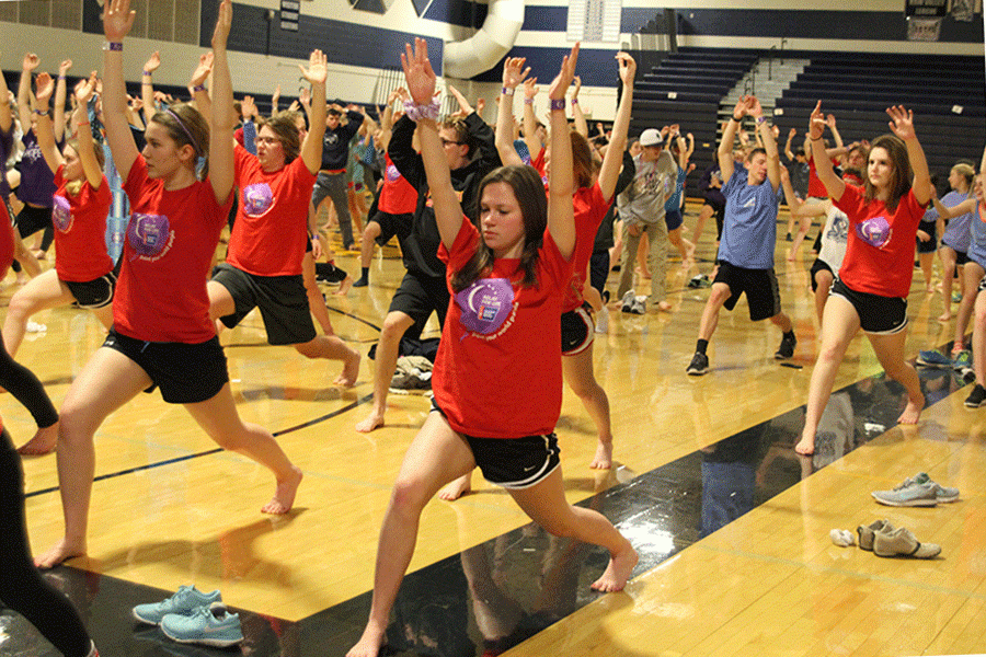 Students participate in sunrise yoga exercises.