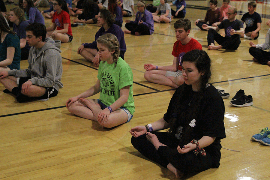 Students participate in sunrise yoga exercises.