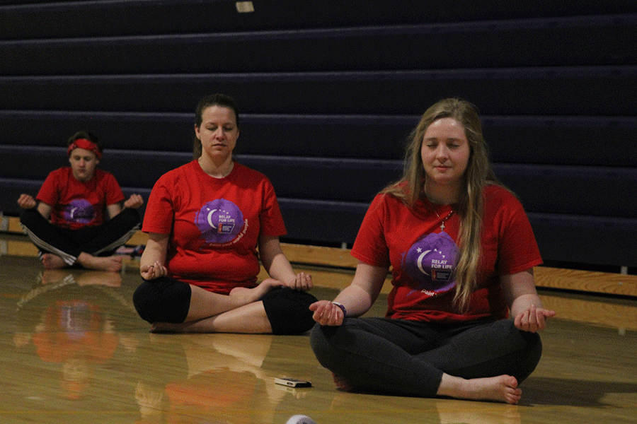 Students participate in sunrise yoga exercises.