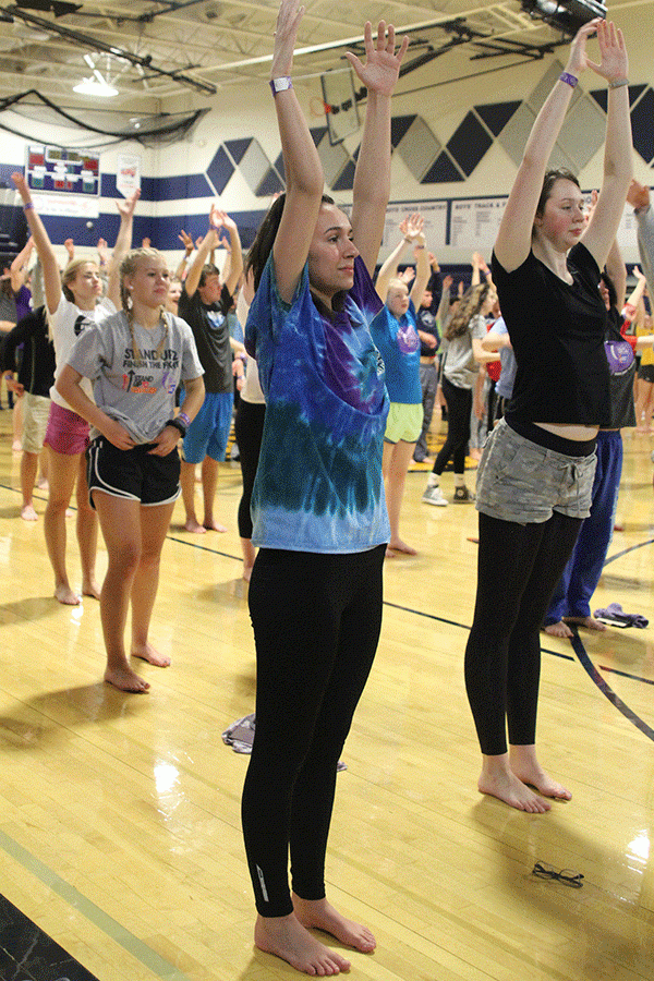 Students participate in sunrise yoga exercises.