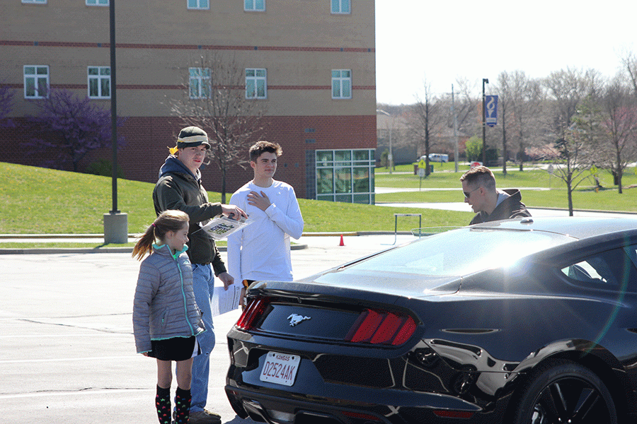 Waiting to test drive a Ford Mustang, senior Kasey Conklin participates in Drive 4 UR School on Saturday, April 2 to raise money for the Booster Club and a club or activity of choice.
