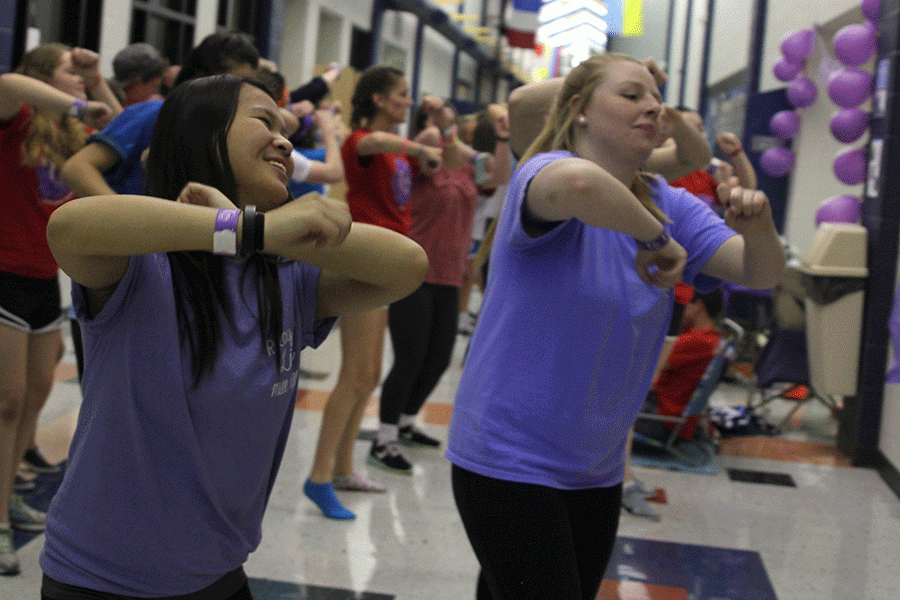 Seniors dance in the hallway. 