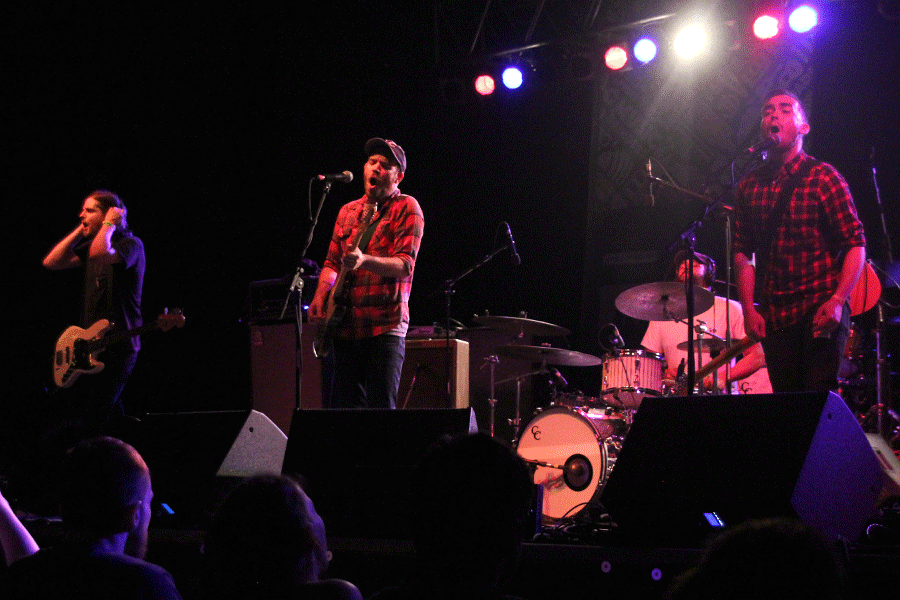 Together, members of All Get Out sing a note as the band performs at CrossroadsKC for Middle of the Map Fest. The band showcased new music at the festival, as it's been five years since All Get Out released a full album.