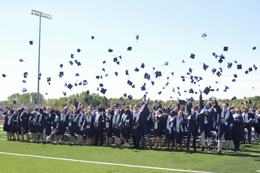 The senior class throws up their graduation caps after receiving their diplomas.