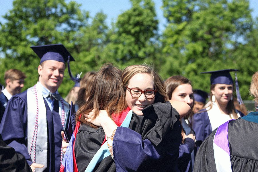 Leaving the field, senior Sherry McLeod hugs a teacher after the ceremony.