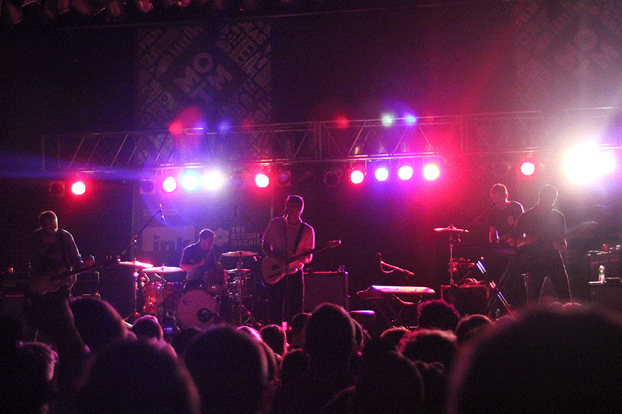 Backlit by stage lights, Cold War Kids perform a headlining set at CrossroadsKC for Day Three of Middle of the Map Fest. The 75-minute set included songs from early in the band's career and recent hits like "First."