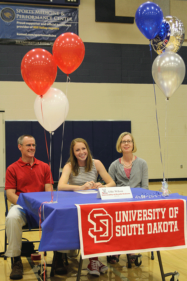 After signing her letter of intent to run track at the Univeristy of South Dakota, senior Ellie Wilson smiles with her family