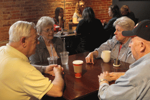 Sitting at one of the table, a group of regulars at Groundhouse Coffee enjoy each other's company on Saturday, April 16.