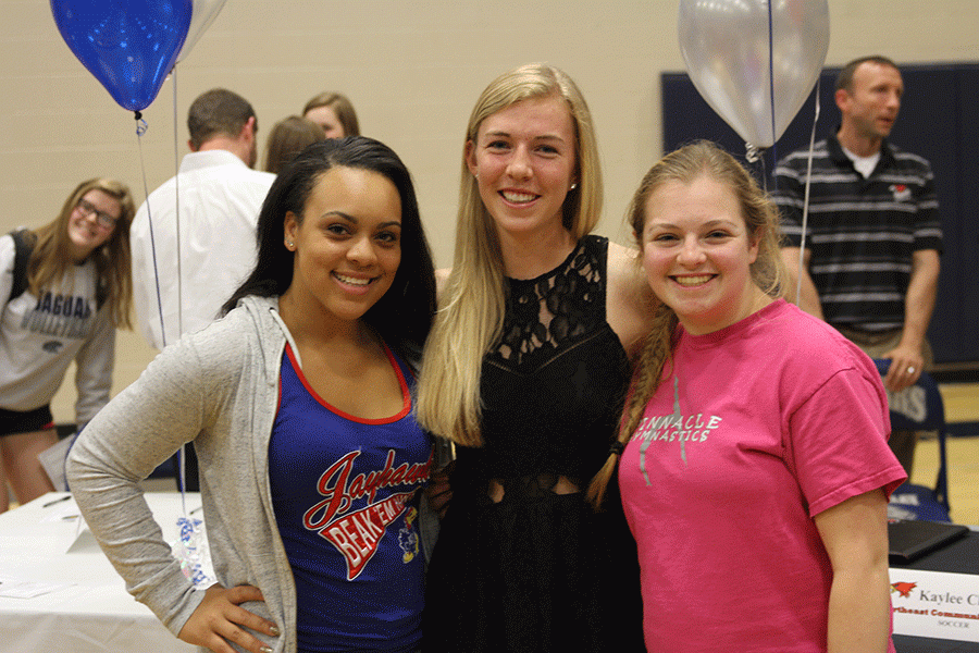 After the signing ceremony, senior Taylor Pullen and senior Emily Borchardt take a picture with senior signee Kaylee Chapman