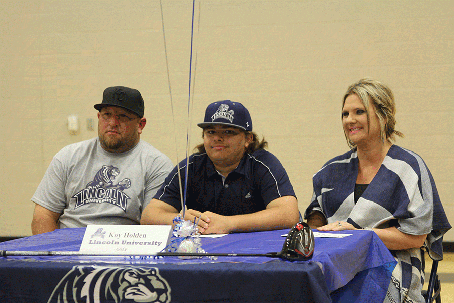 After signing his letter of intent to play golf at Lincoln University, senior Koy Holden smiles at the camera.