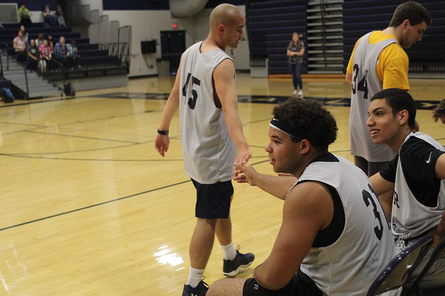 Senior Anthony Brown shakes teammate senior Chase Midyett. 