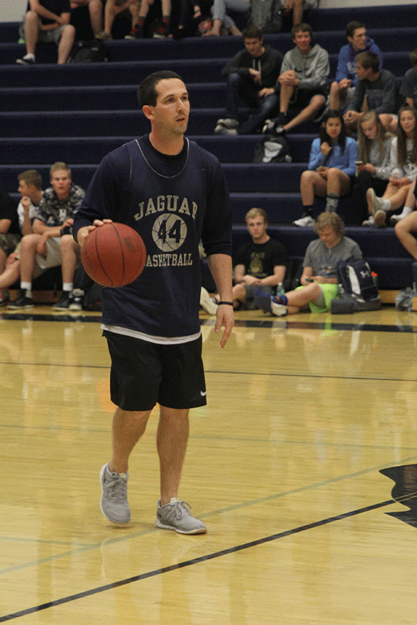 Physical education teacher TJ ONeill dribbles the ball down the court. 