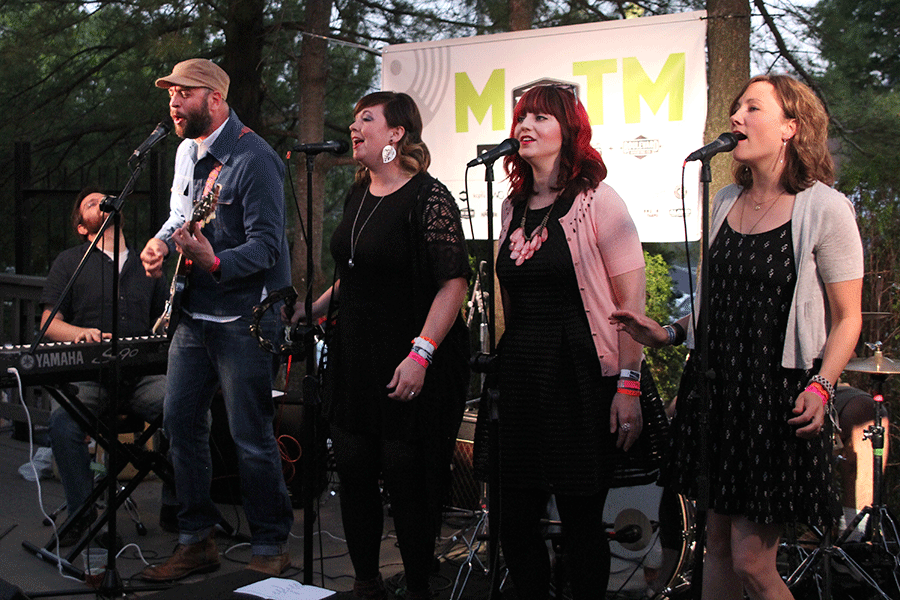 In unison, My Oh My! lead vocalist-guitarist A.M. Merker and vocalists Sarah Dolt, Stephanie Gaume and Melissa Geffert sing a note. My Oh My!, an eight-piece Americana group, performed at the Californos patio stage for Day Two of Middle of the Map Fest.