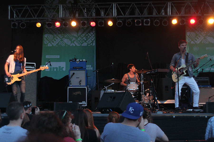 As the sun goes down, The Noise FM performs for Day Three of Middle of the Map Fest at CrossroadsKC. The last band from Kansas City to perform at CrossroadsKC that night, The Noise FM's set also included many jokes from lead vocalist/multi-instrumentalist Alex Ward and vocalist-bassist Barry Kidd.
