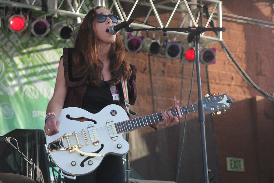 Backed by her band, The Wild Type, Rachel Mallin sings at CrossroadsKC during Day Three of Middle of the Map Fest. Mallin's four-piece band includes a guitarist, a bassist, a keyboardist and a drummer, and three members also sang backing vocals.
