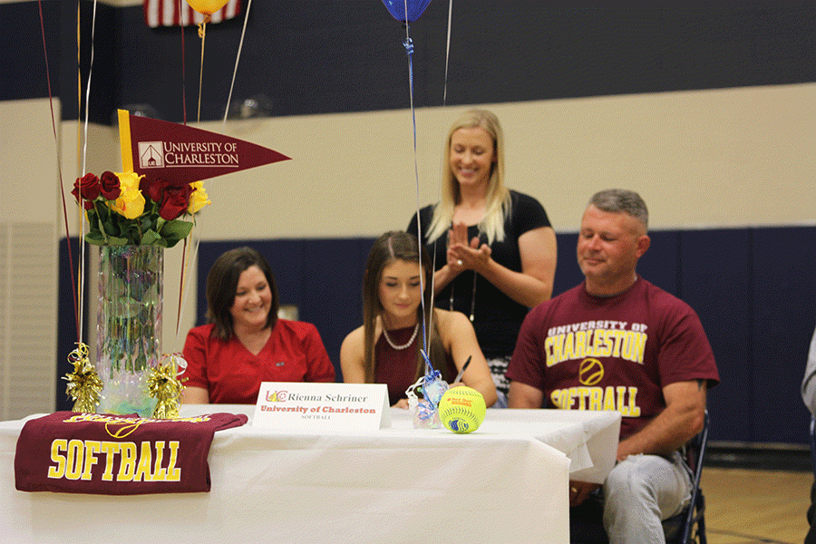 During the ceremony, senior Rienna Schriner signs her letter of intent to play softball at the University of Charleston.