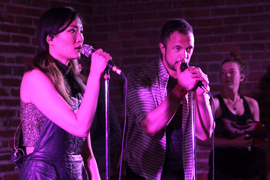 Clutching their microphones, San Fermin vocalists Charlene Kaye and Allen Tate sing with the band to headline Day Two of Middle of the Map Fest on the Californos indoor stage. A baroque pop octet from New York City, San Fermin's Middle of the Map Fest set was its second in Kansas City.