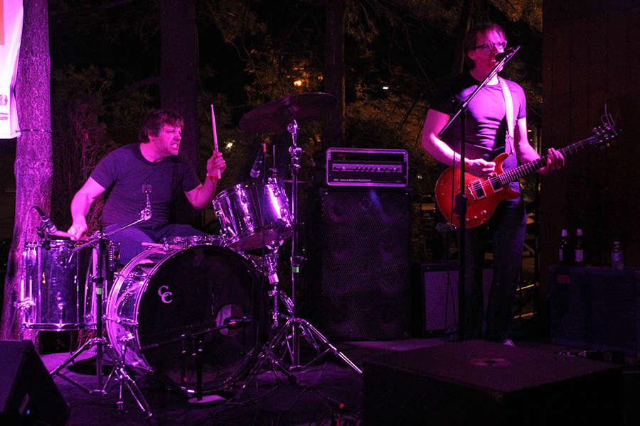 On a dimly lit stage at the Californos patio, The Sluts perform at Day Two of Middle of the Map Fest. The Lawrence-based garage rock duo played music off its first extended play and unreleased songs.