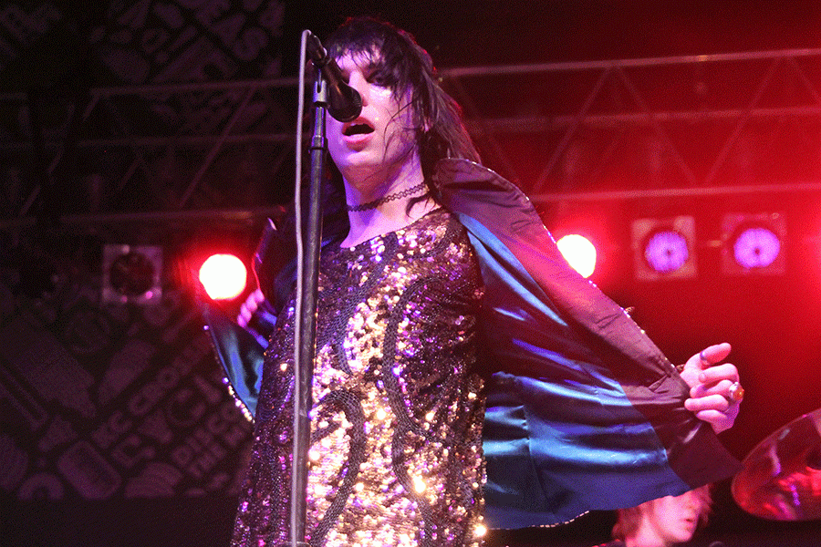 Pulling off a jacket to reveal a gold-sequined outfit, The Struts lead vocalist Luke Spiller sings a note as the band performs for Day Three of Middle of the Map Fest. The set, just before Cold War Kids at CrossroadsKC, was the bands first in Kansas City.