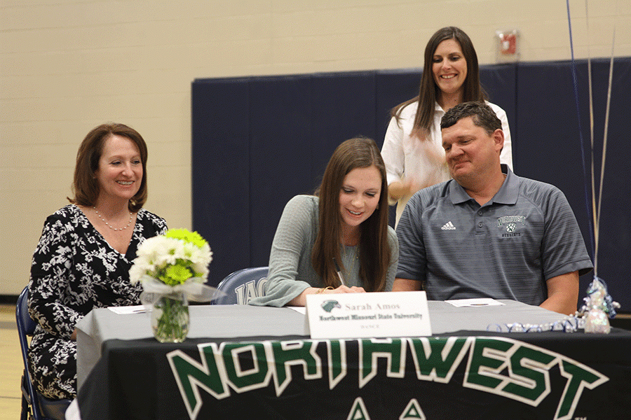 Senior Sarah Amos signs her letter of intent for dance at Northwest Missouri State University.