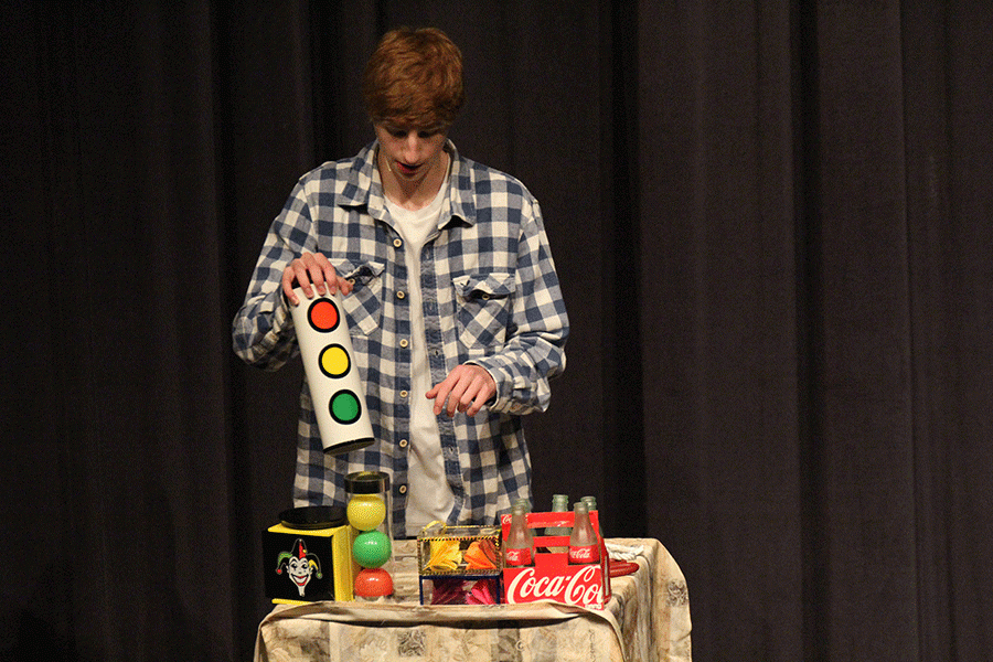 Performing a magic trick, sophomore Jason Easley reveals his trick.  