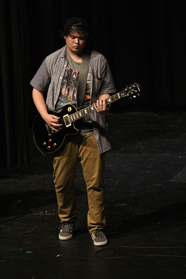 Junior David Kuk strums his guitar in his performance at the Talent Show. 