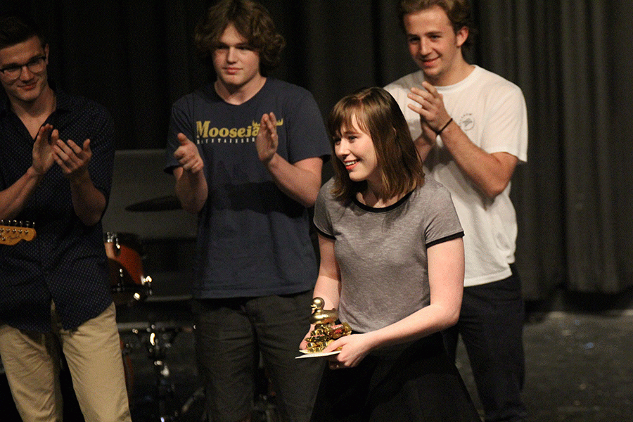 Senior Audrey Linsey smiles as she receives a first place trophy. 