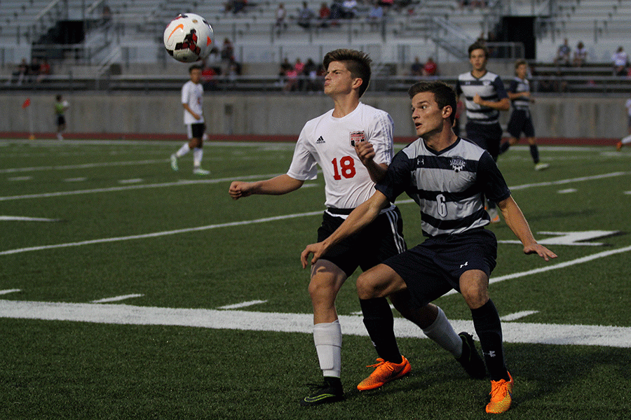 With the ball in motion, senior Sam Lopez fights for possession of the ball on Tuesday, Aug. 30. 