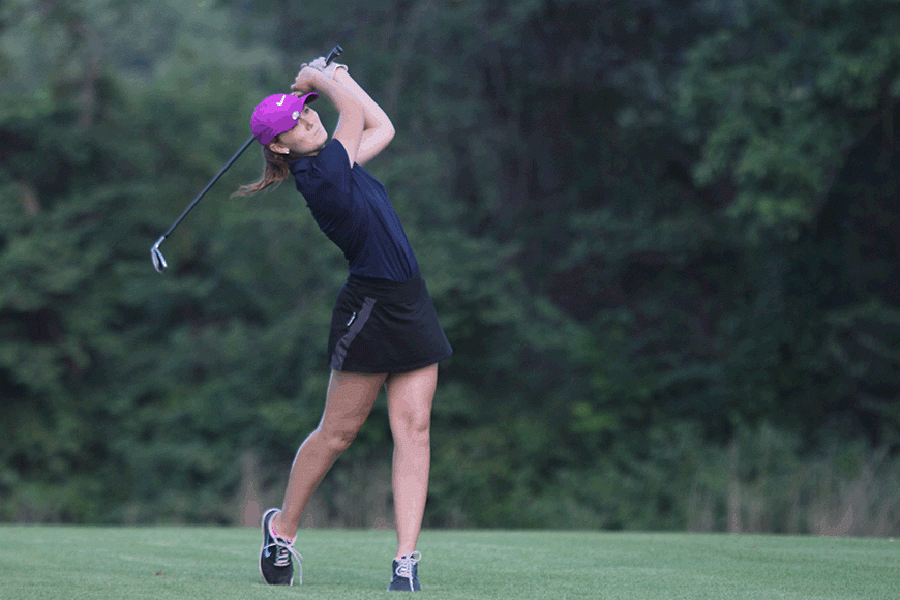 After her swing, senior Grace Van Inwegen watches her ball fly in the air at the Lake Quivira Golf Course on Monday, Aug. 29. The team finished second with a score of 368.