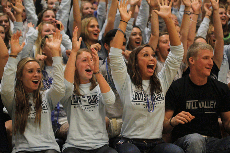 During the 2015 homecoming pep assembly, former students Ellie Wilson and Katie Burke join in doing the traditional roller coaster.