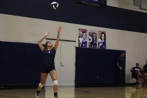 Senior Emma Mantel leans back for a hard hitting serve.