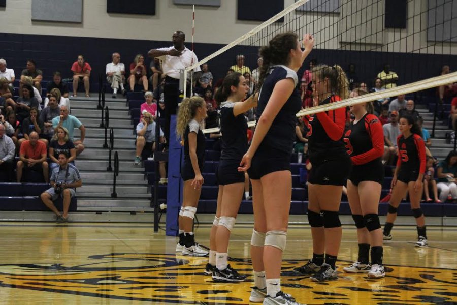 Seniors Maggie Bogart and Morgan Thomas, along with junior Ava Taton, prepare for an incoming ball on Tuesday, Aug. 30. The Jaguars won all three games against Shawnee Mission North.