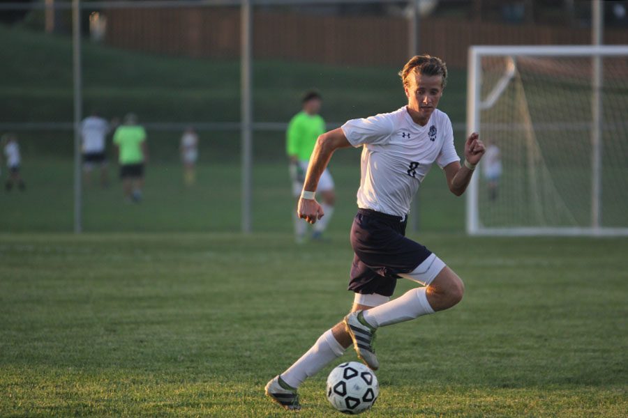 Senior Spencer Butterfield runs alongside the ball to set up a play for the team.