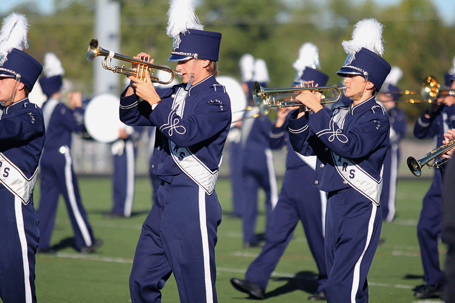 Senior trumpet player Spencer Butterfield marches forward on the field during movement three. Blue Band received a two rating overall at the Bonner Springs High School competition on Thursday, Sept. 29. 