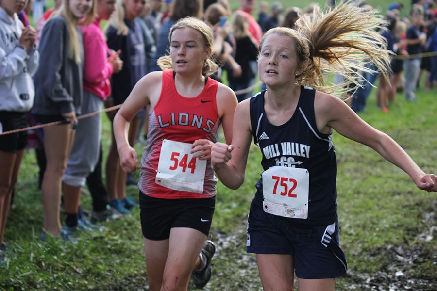 Freshman Jenna Walker runs ahead of her opponent at the end of the Bonner Springs race on Saturday, Sept. 17.