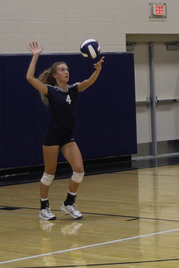 Senior Morgan Thomas serves the ball.