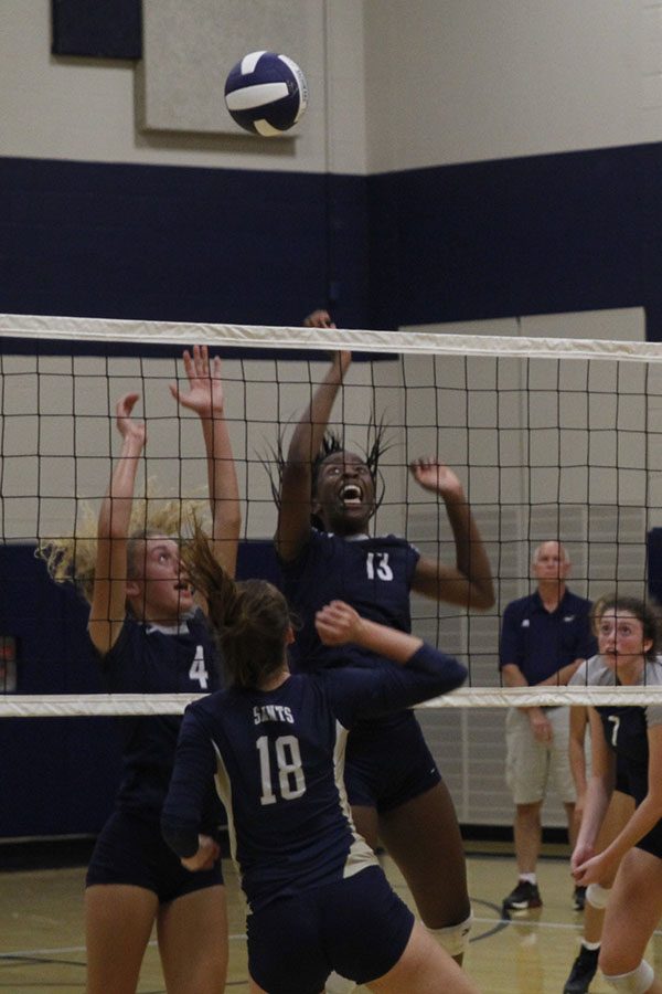 Senior Morgan Thomas and junior Abigail Archibong prepare to return the Saints ball.