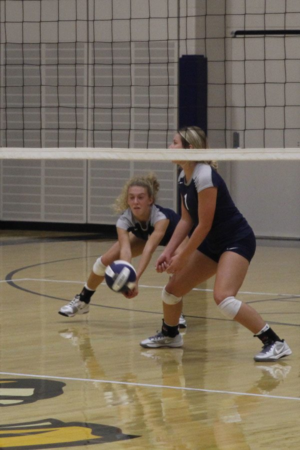 Senior Morgan Thomas bends to bump the ball up to her teammates.